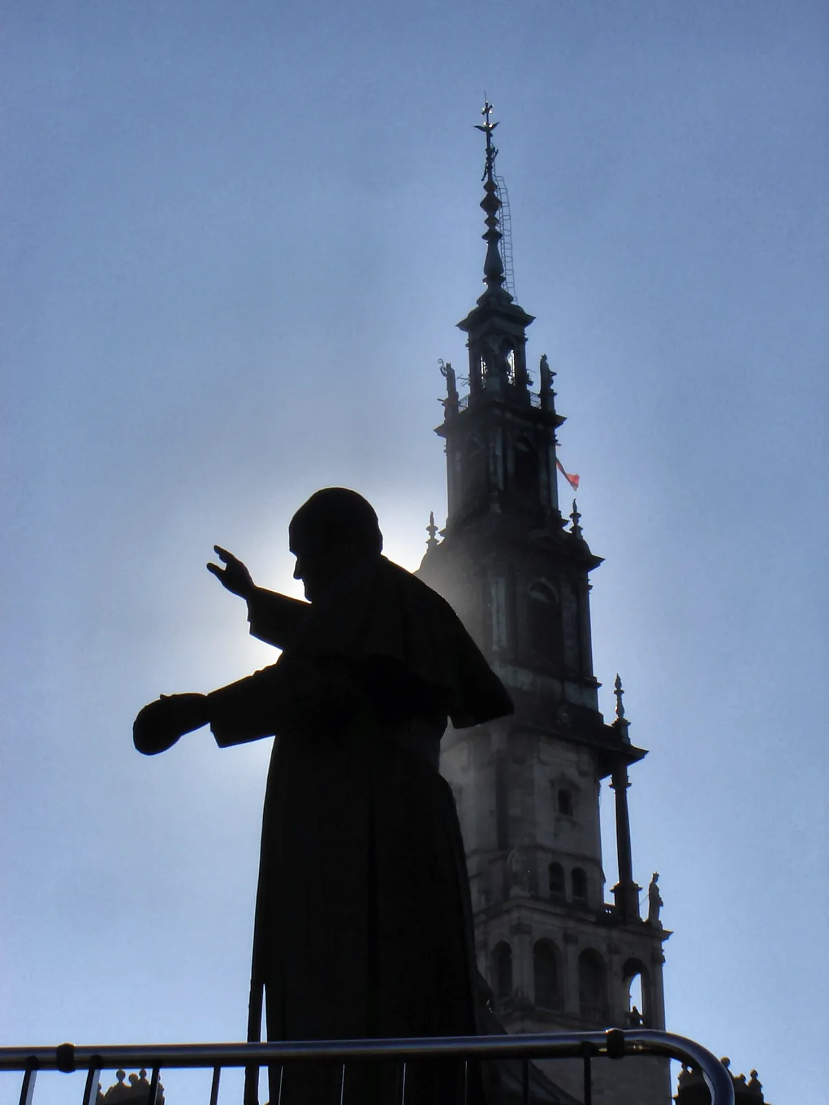 Saint John Paul II statue with the Jasna Gora tower in Czestochowa