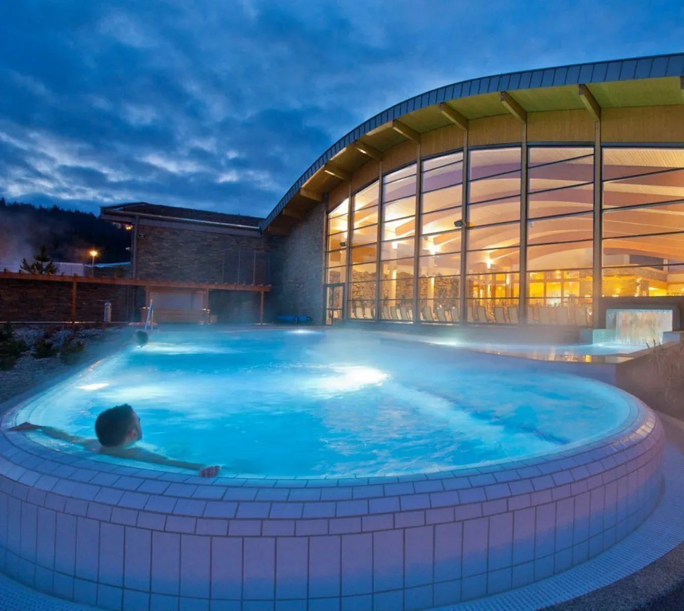 Steaming outdoor thermal pool in the Zakopane region at evening