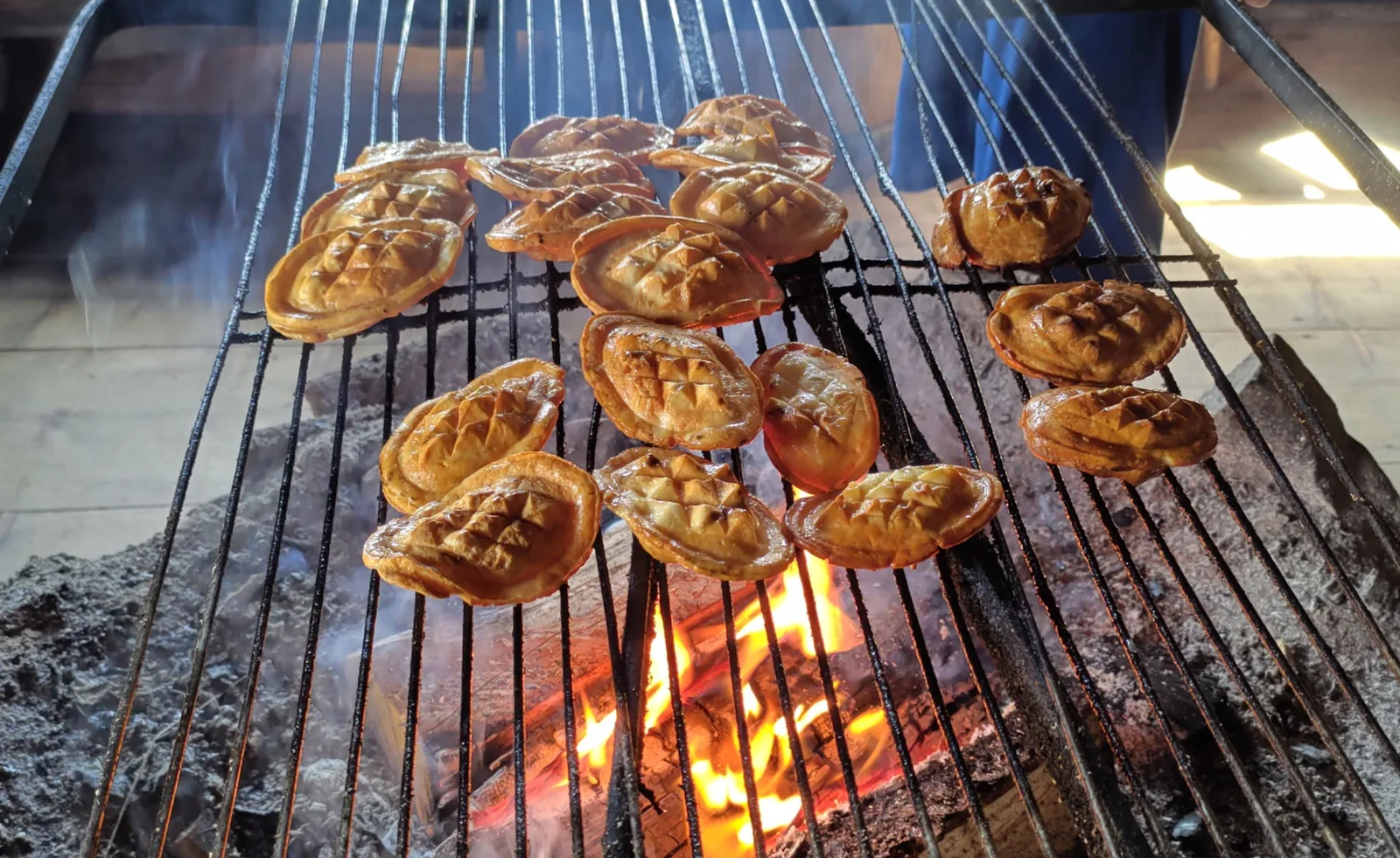 Traditional oscypek-style cheese grilling over an open fire